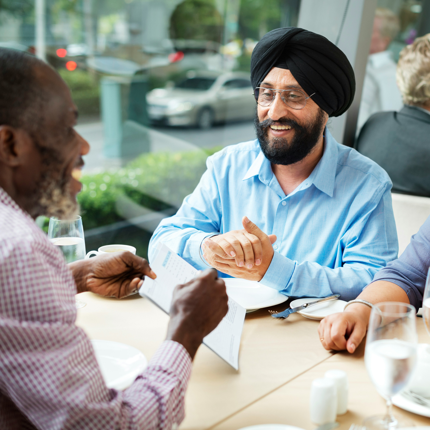 Two men practicing their English speaking at a cafe in London