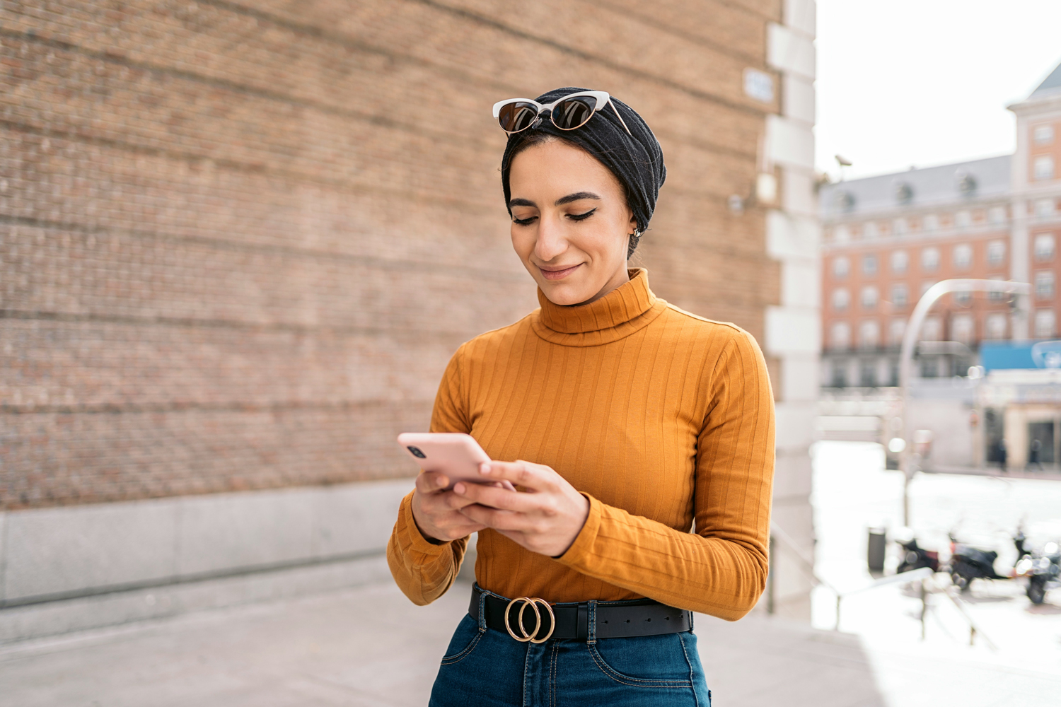 Woman using English to learn on a phone in Hounslow